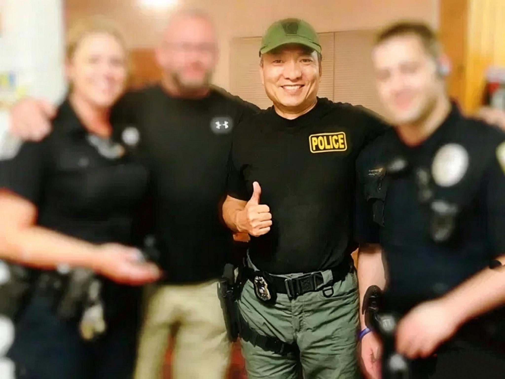 Eddie Wei Zhao with law enforcement officers
